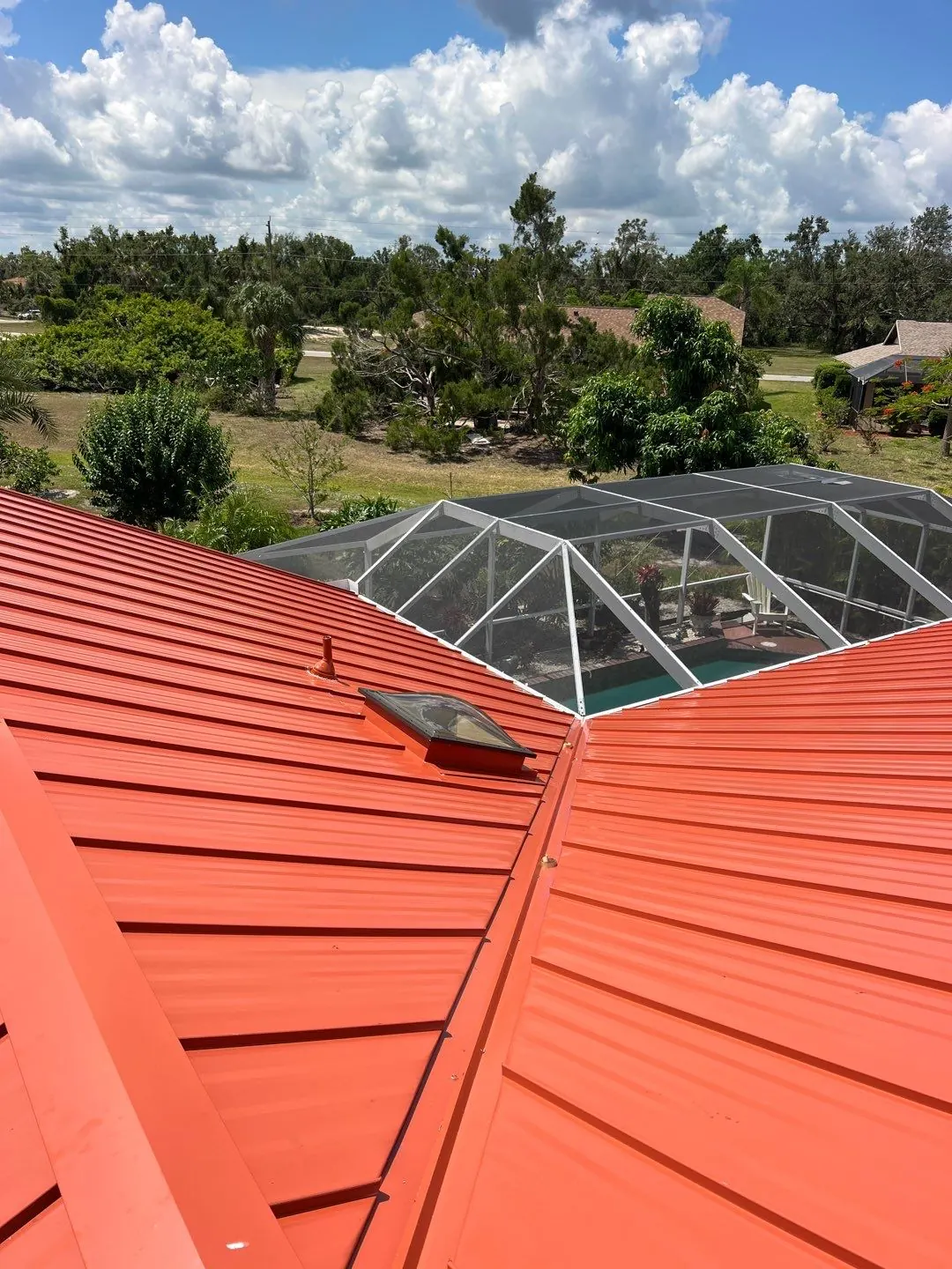 After: the same roof in terracotta standing-seam metal