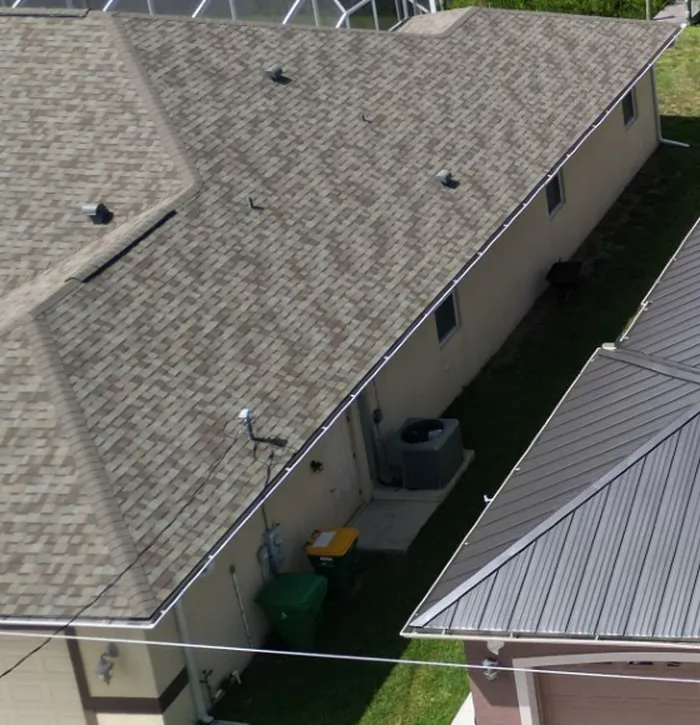 An architectural shingle roof in a Southwest Florida neighborhood, seen from above