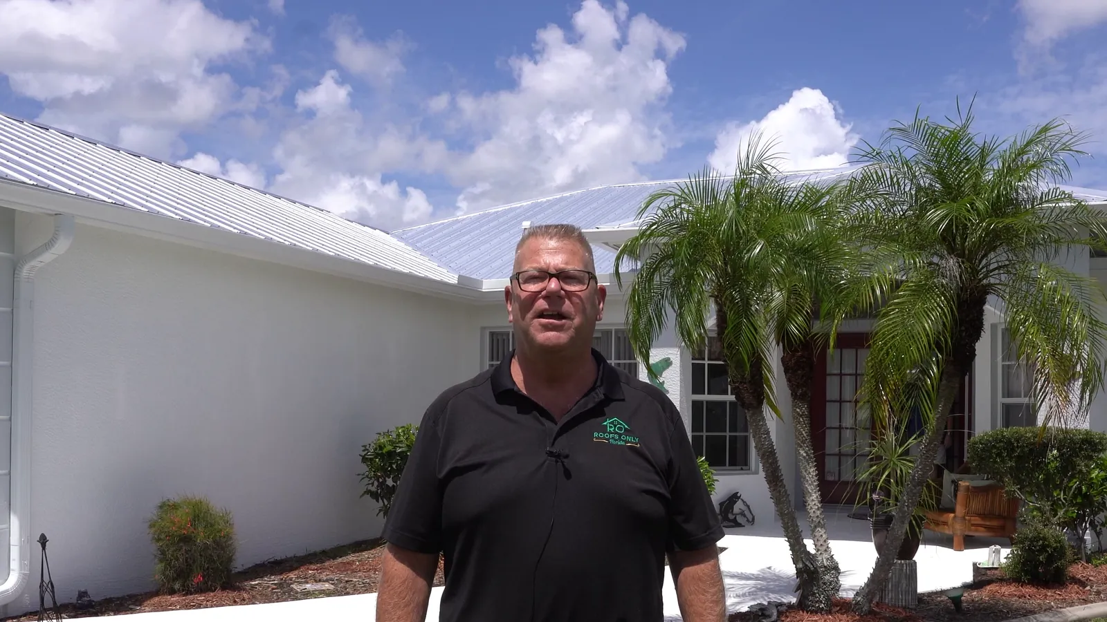 Michael Vecchione outside a Southwest Florida home with a new metal roof
