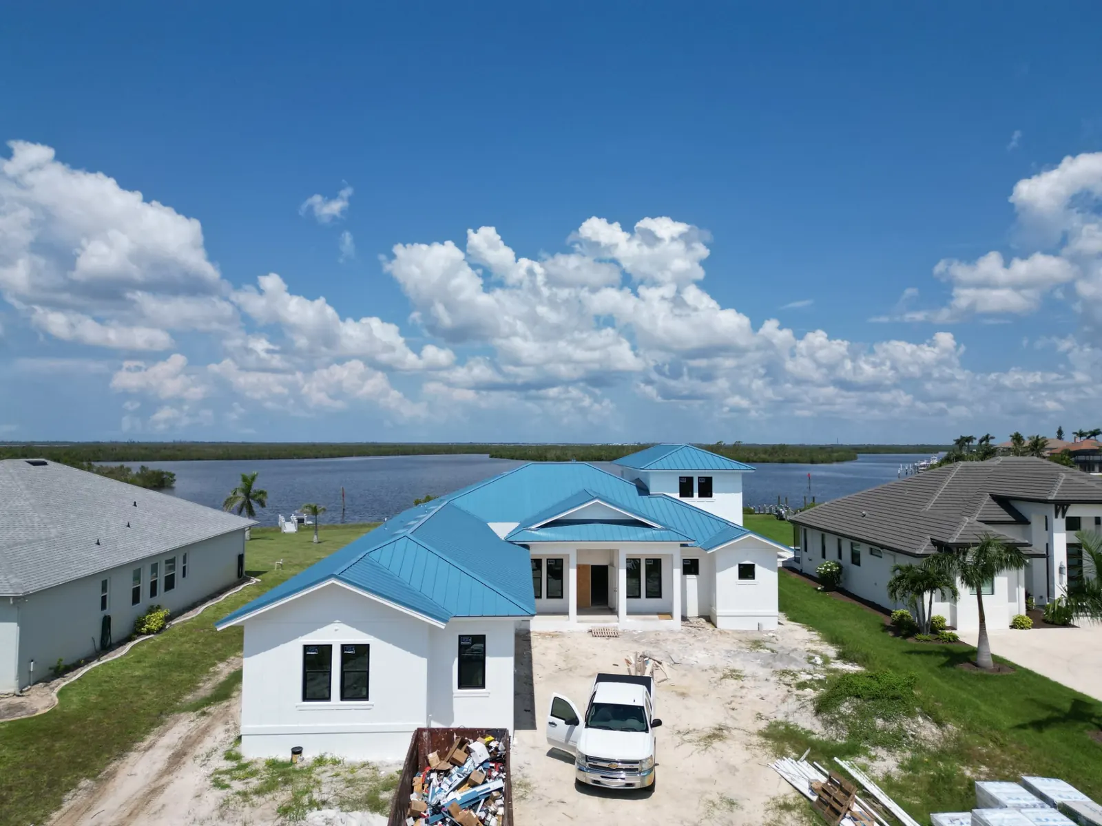 Drone view of a new blue metal roof by Roofs Only Florida on a waterfront home