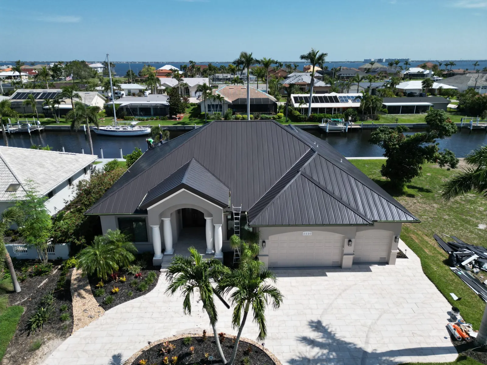 A charcoal standing-seam metal roof on a canal home in Southwest Florida