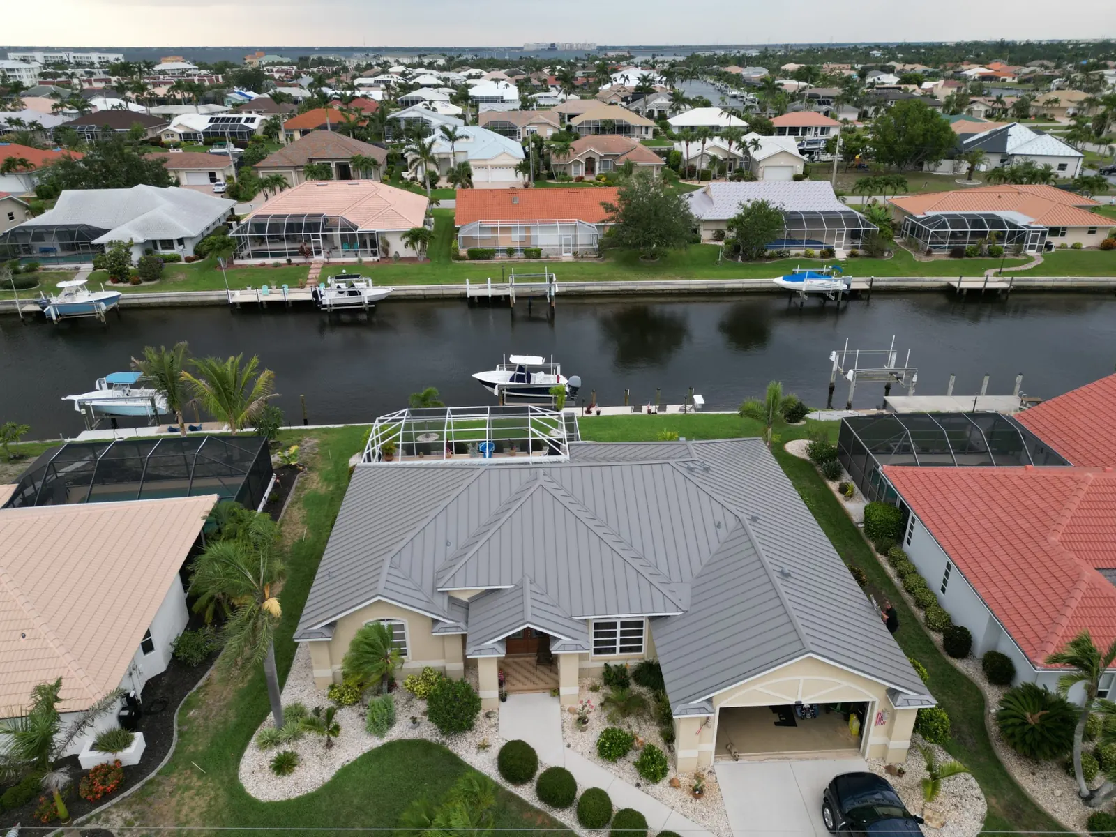 Gray standing-seam metal roof in a canal neighborhood