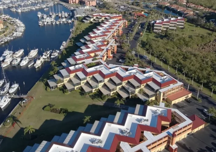 Low-slope roofs on waterfront buildings beside a marina